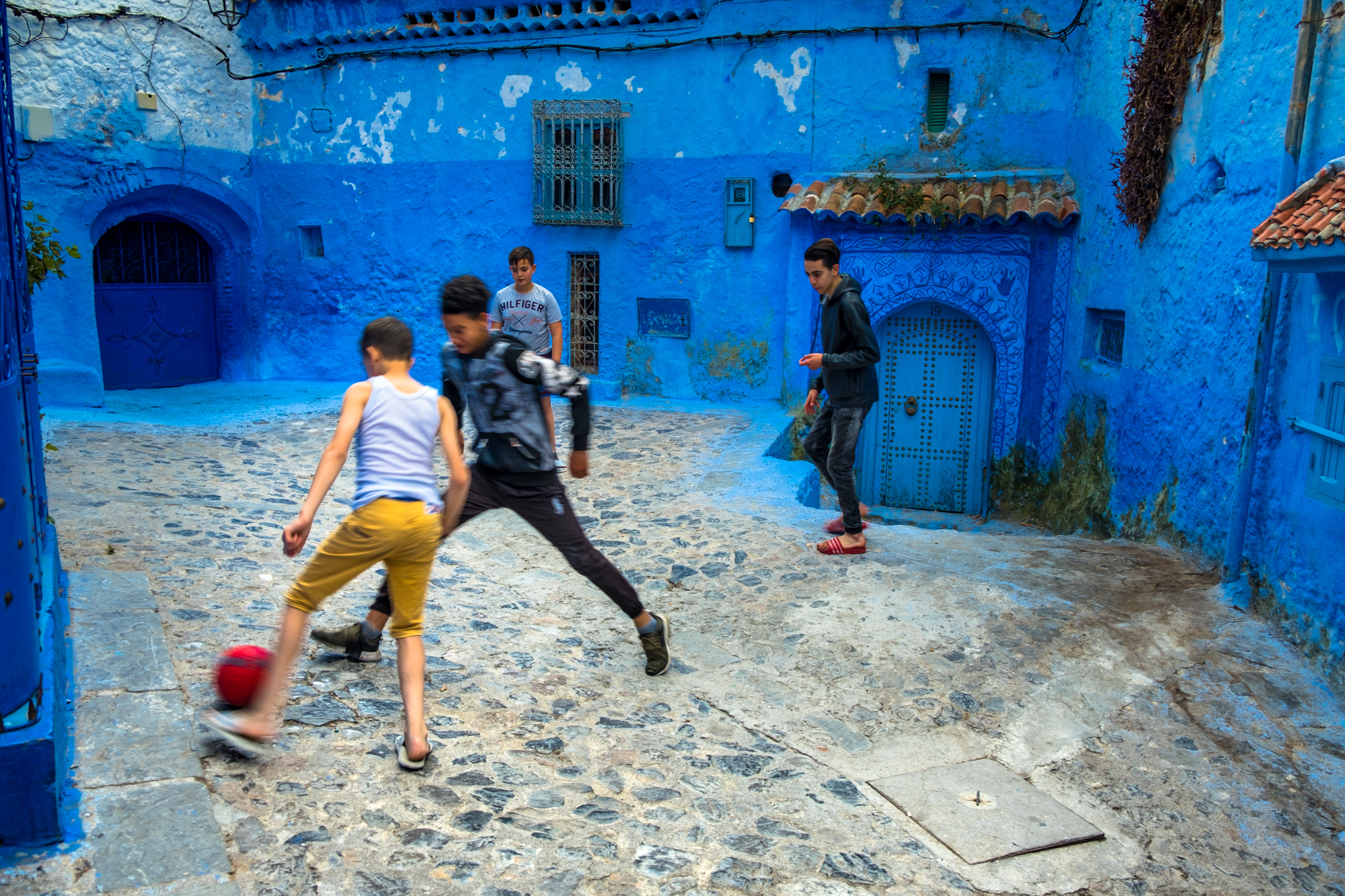 Soccer with 2 on each side in a tiny courtyard in Chefchaoeun, Morocco