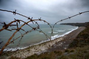 Barbed wire along the bluff tops at the Normandy coast, looking towards Omaha Beach