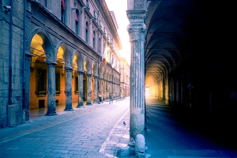Early morning light filtering through the portico columns in Bologna