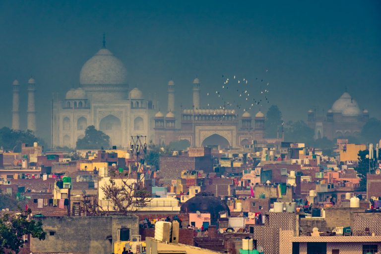 View of the Taj Mahal from across the old town of Agra, on a foggy winter morning.
