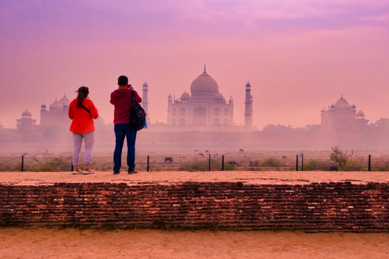Visitors soak in the Taj rear view from the fenced out Mehtab Bagh across the Yamuna
